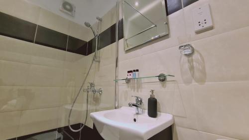 a bathroom with a sink and a glass shower at STAY Napa Velvet Apartment in Ayia Napa