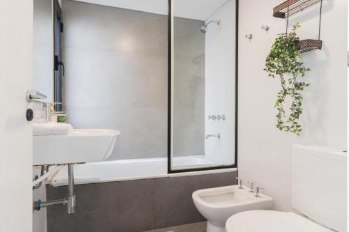 a bathroom with a sink and a toilet at Fliphaus Santa Fe 5100 - 3 Bd Pool & Bbq in Buenos Aires