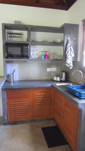 a kitchen with a sink and a counter top at Avalon Village Resort in Induruwa