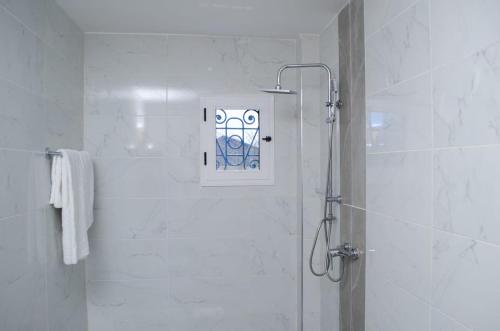 a shower with a glass door in a bathroom at Residence Eliz in Kabrousse