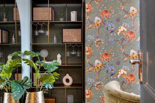 a room with a bookcase with floral wallpaper at Insta-worthy Loft on Historic Chester Rows, Sleeps 4 & Free Parking in Chester