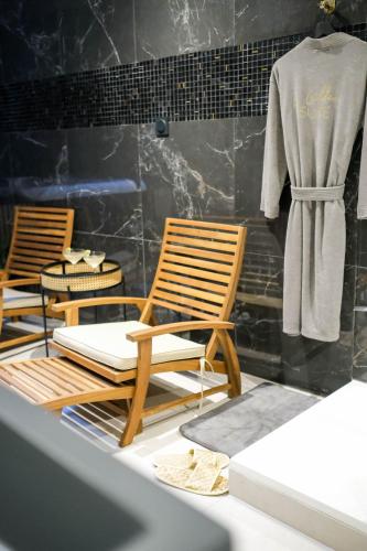a room with two chairs and a robe on a mannequin at La Golden Suite in Cambrai