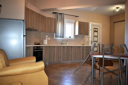 a kitchen with a table and a dining room at Smailis apartment 2 in Lygourio