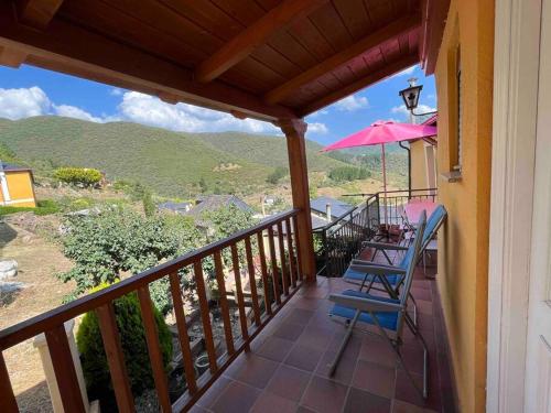 a balcony with a table and a pink umbrella at Medulillas 2 A solo 2000 m de Las Médulas in Yeres