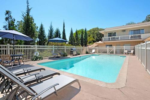 a swimming pool with chairs and an umbrella at Designer Poolside 1Bed1Bth Retreat in La Mesa