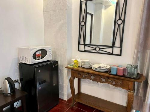 a microwave sitting on top of a table in a room at MARIKINA 32 sqm Studio for Transients w WiFi 40 inch TV Parking in Manila