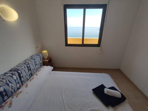 a bedroom with a large bed with a window at Cumbre Moraig in Benitachell