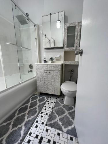 a bathroom with a toilet and a sink and a shower at Ysabel in New York