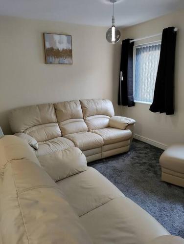 a living room with a sectional couch at Droitwich Spa centre apartment in Droitwich