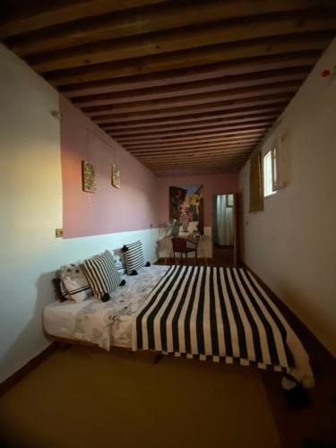 a bedroom with a large bed in a room at Tarbi'aat Tetaoun 44, 17th century heritage in Tétouan