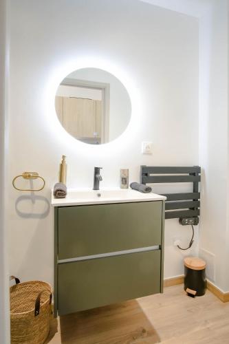 a bathroom with a sink and a mirror at La Capsule - Appartement Design et Cosy in Cambrai