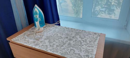 a wooden dresser with a iron on top of it at 2 bedroom apartment metro Vasilkovskaya in Kyiv