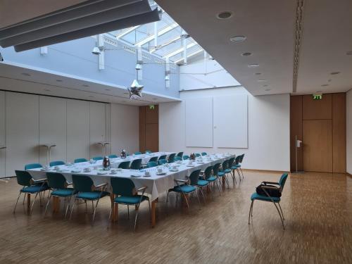 a large conference room with a long table and chairs at Green Night Hotel in Falkenstein