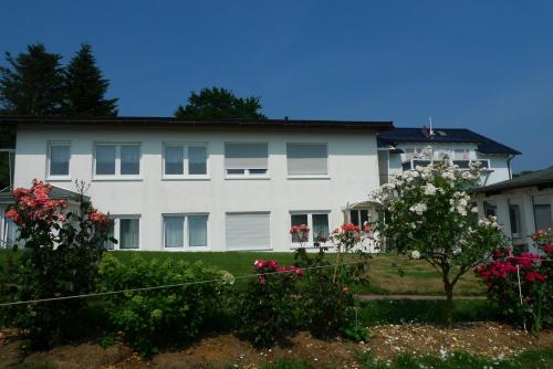 a white house with flowers in front of it at Rosenhof in Binz in Binz