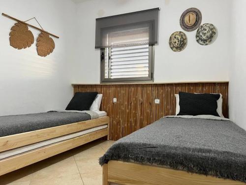 מיטה או מיטות בחדר ב-Meller apartmenr