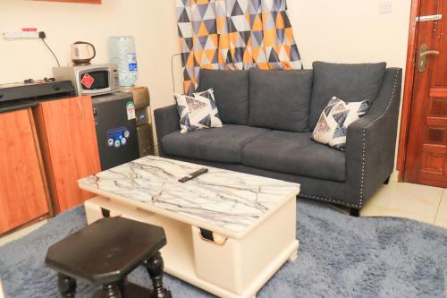 a living room with a couch and a coffee table at The Modern loft in Nairobi