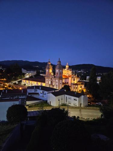 a large building in a city at night at Casa das Acácias in Cabeceiras de Basto