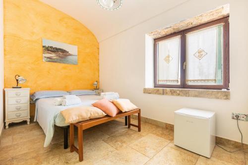 a bedroom with a bed and a window at Casale de li Canti in Marina di Pescoluse