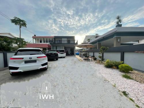 a parking lot with cars parked in front of a house at Ipoh 19A Villa for 12pax 6 Carpark with BBQ by IWH in Ipoh