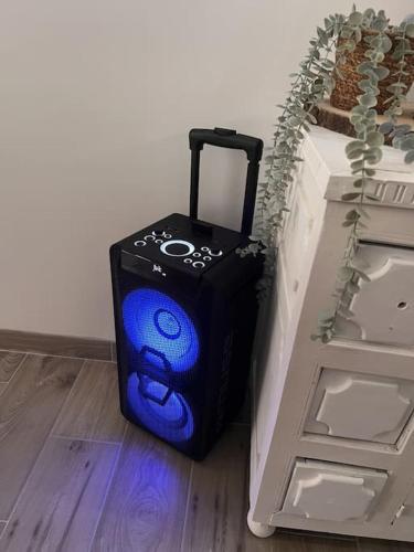 a blue suitcase sitting on the floor next to a wall at Cocon Classé 3 Etoiles - Love et Détente - SPA in Carpentras