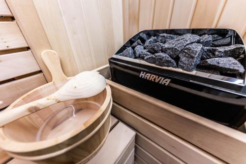 a wooden spoon next to a box of coal at Premium Lux Apartman Čačak in Čačak