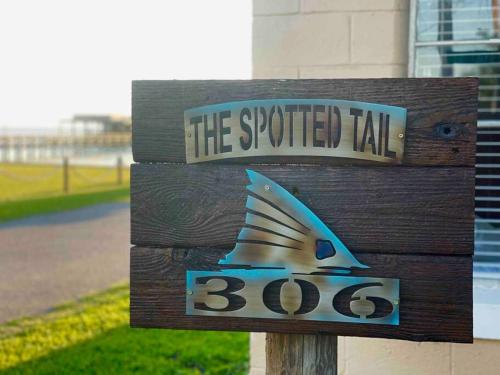a sign that says the specified tail with a fish on it at The Spotted Tail in Hackberry