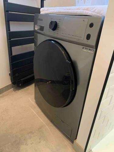 a washing machine is sitting in a room at Cocon Classé 3 Etoiles - Love et Détente - SPA in Carpentras