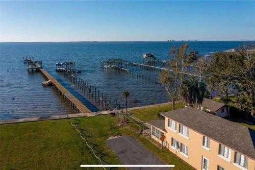 a dock in the water next to a house at The Spotted Tail in Hackberry
