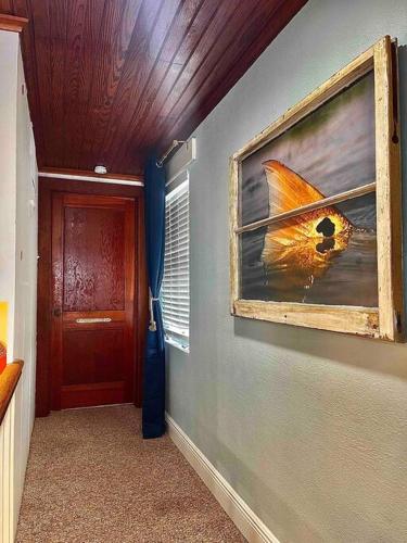 a hallway with a painting of a bird on the wall at The Spotted Tail in Hackberry