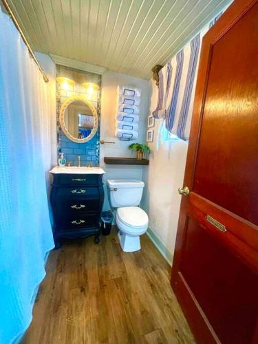a small bathroom with a toilet and a sink at The Spotted Tail in Hackberry