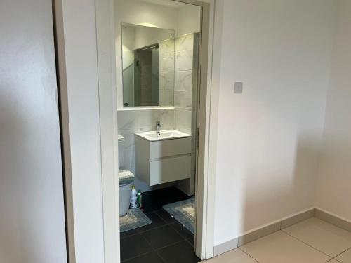 a bathroom with a sink and a mirror at Royal Luxury Apartments in Accra