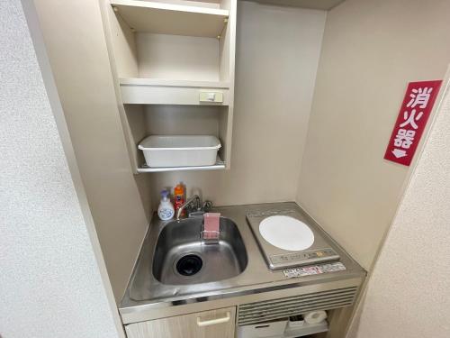 a small kitchen with a sink in a small room at NORTH LIVE 2 in Ōdōri