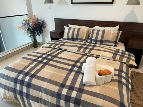 a bed with two towels and a tray of food on it at Royal Luxury Apartments in Accra