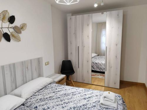 a bedroom with two beds and a sliding glass door at Los Caños de Rivero, con GARAJE y WIFI, VUT-4366-AS in Avilés