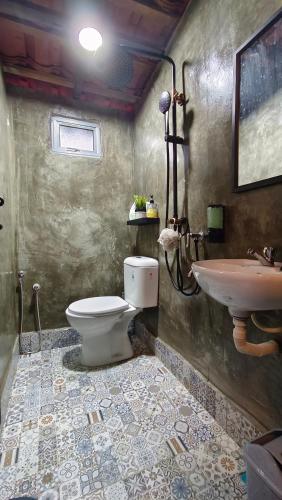 a bathroom with a toilet and a sink at Kampung Cheq Homestay - Private Pool, Free Wifi, Netflix in Penaga