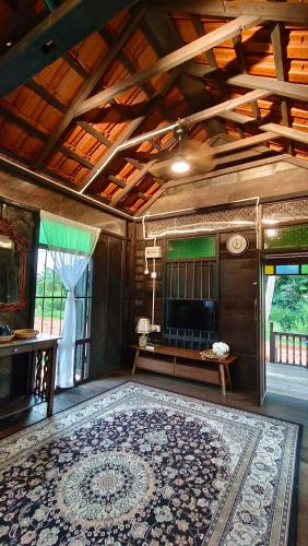 a large room with a large rug on the floor at Kampung Cheq Homestay - Private Pool, Free Wifi, Netflix in Penaga
