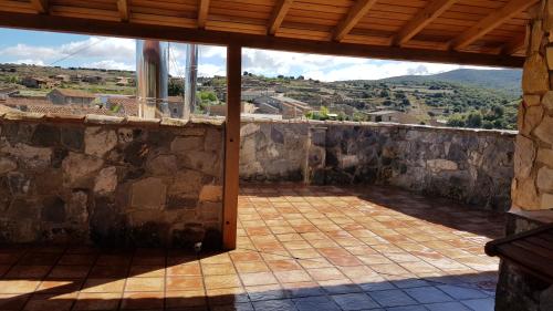 a view of a patio with a stone wall at Las Abadías in San Felices