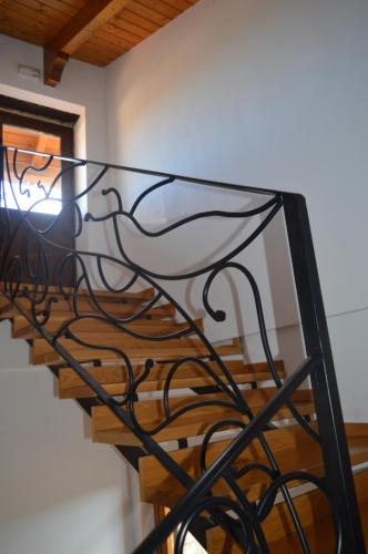 a spiral staircase with black metal railings at Las Abadías in San Felices