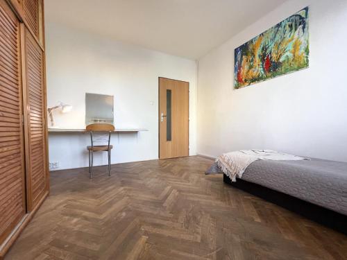 a bedroom with a bed and a desk in it at Cozy room near the city centre in Košice