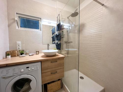 a bathroom with a washing machine and a shower at Cozy room near the city centre in Košice