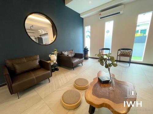 a living room with a table and a mirror at Ipoh 19A Villa for 12pax 6 Carpark with BBQ by IWH in Ipoh