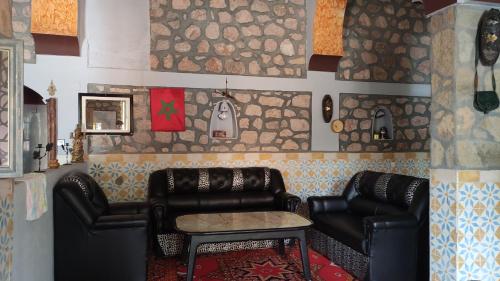 a living room with two leather chairs and a table at Hotel AZUL Todra Gorges in Tinerhir