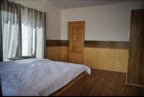 a bedroom with a large bed and a window at gultuk home stay in Leh