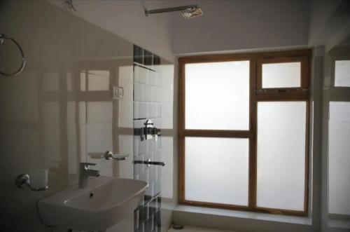 łazienka z umywalką i oknem w obiekcie gultuk home stay w mieście Leh