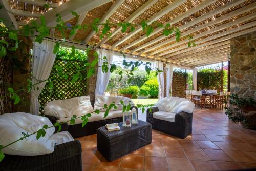 a living room with two couches and a table at Patio Relax - 200m from beach - Villasimius in Notteri