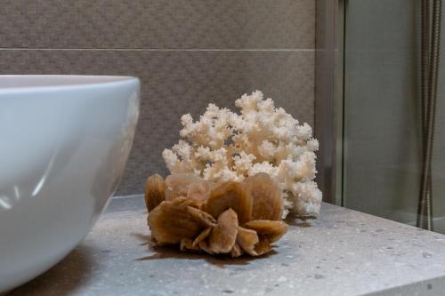 a pile of white stuff on a counter next to a bowl at Patio Relax - 200m from beach - Villasimius in Notteri