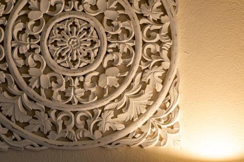 a close up of a wall with a carving on it at Patio Relax - 200m from beach - Villasimius in Notteri