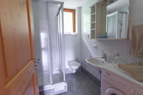 a bathroom with a shower and a sink and a toilet at Pretzerhof in Campo di Trens