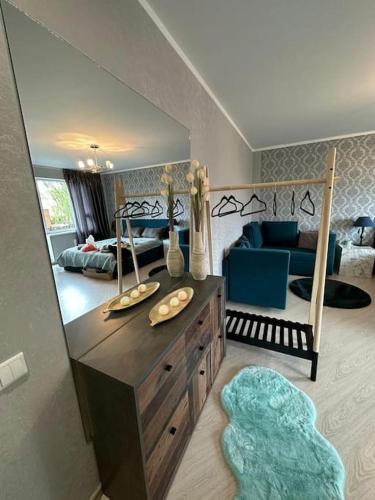 a room with a bedroom with a bed and a living room at Hugo 2 in Jēkabpils