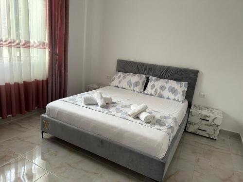 a bedroom with a bed with white sheets and pillows at Shell Home golem 1 in Golem